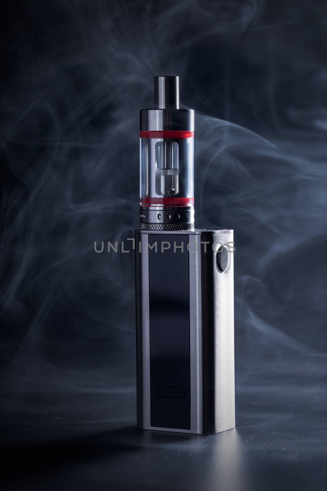 Electronic cigarette close-up on a black background in smoke