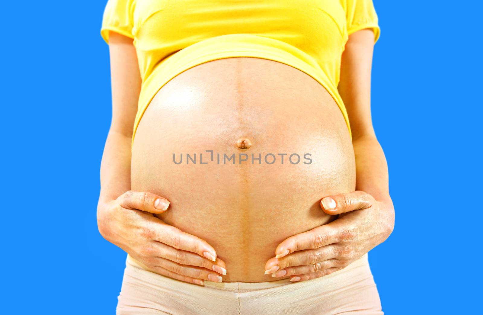closeup stomach of pregnant woman by ssuaphoto