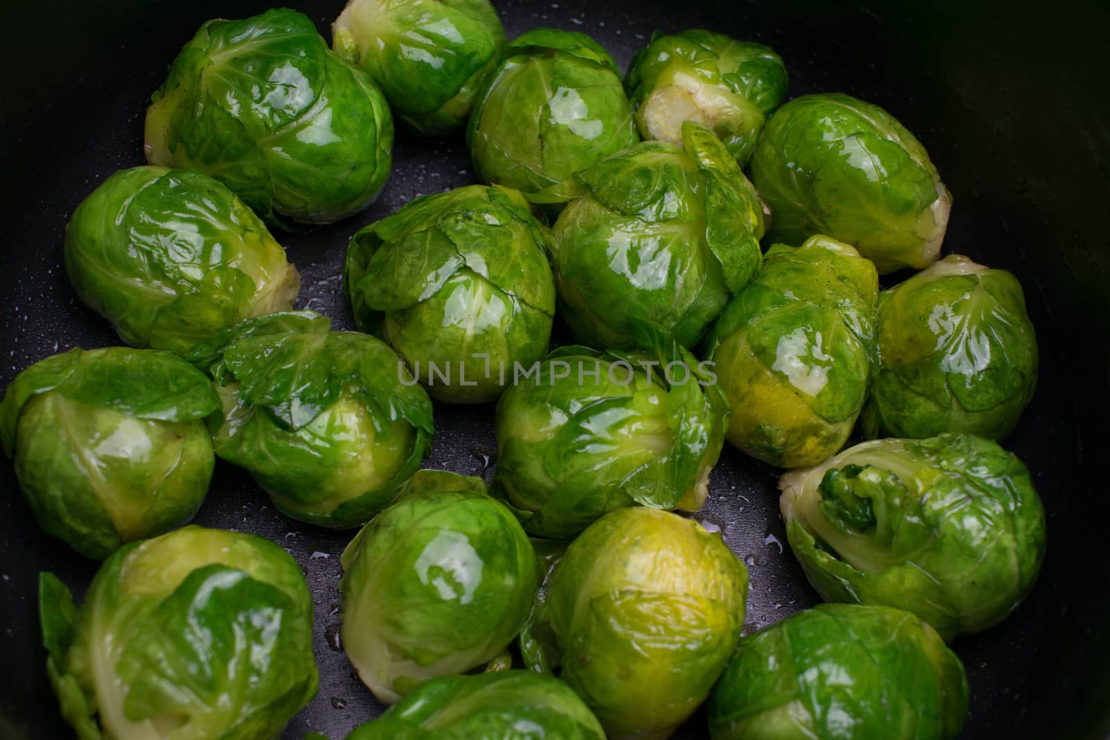 Many cooked Brussells sprouts close up background