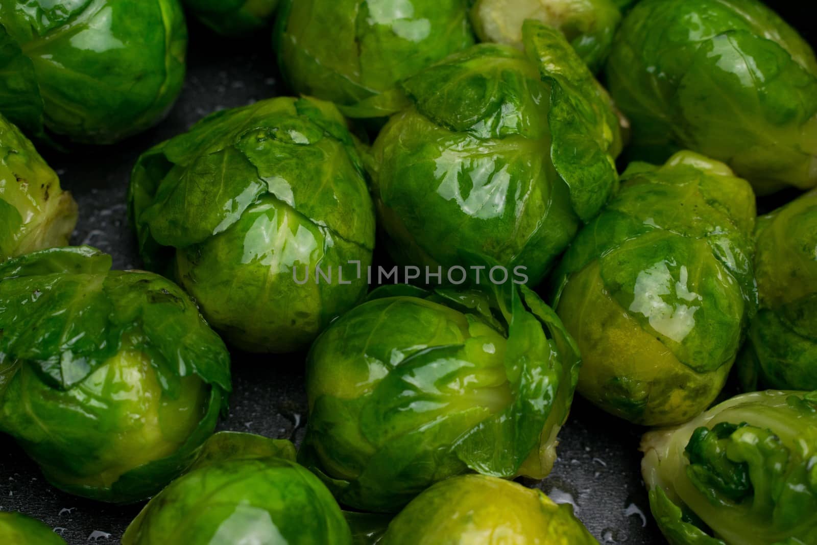 Many cooked Brussells sprouts close up background