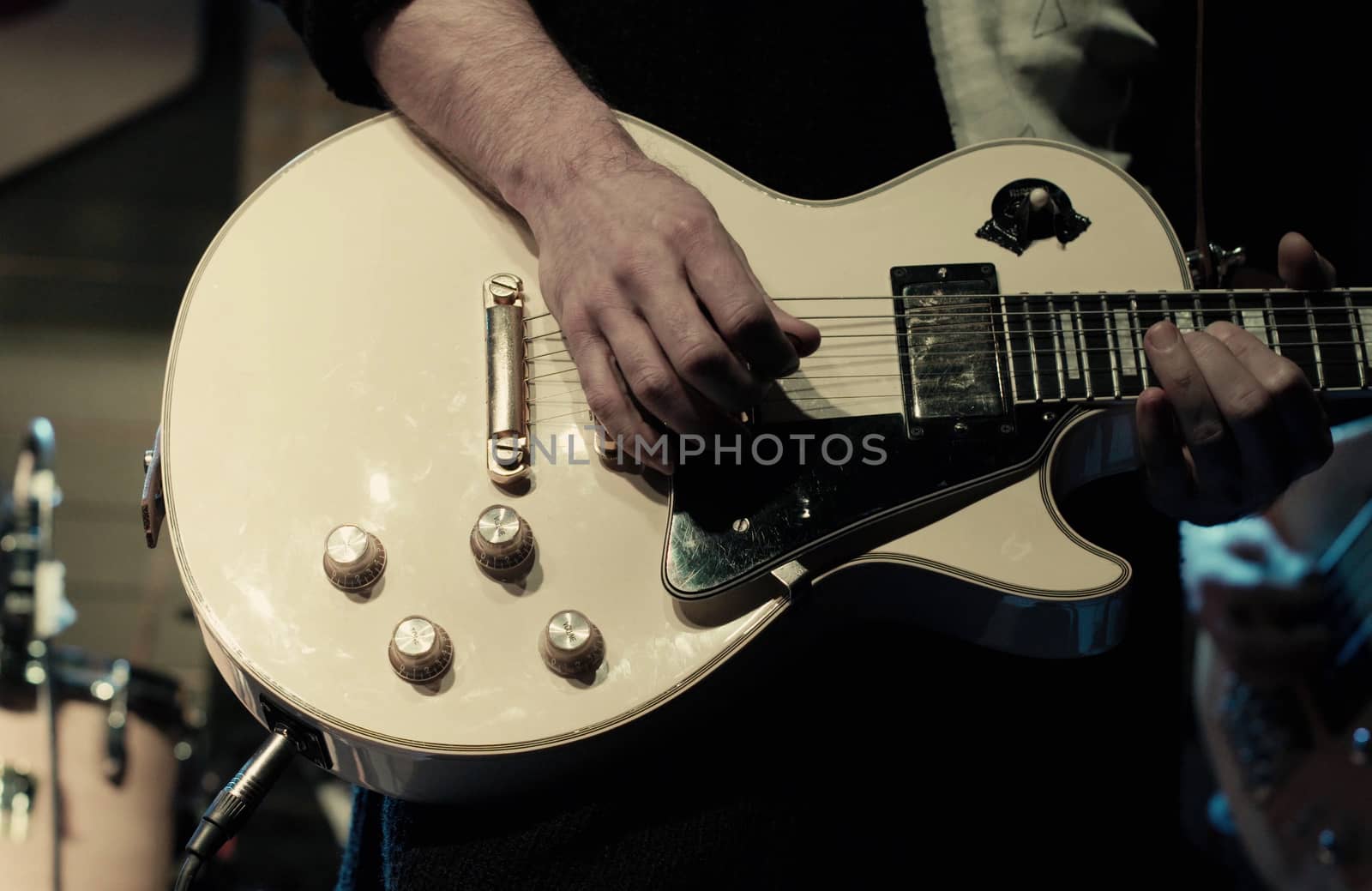 Man's hands playing electric guitar. Close up