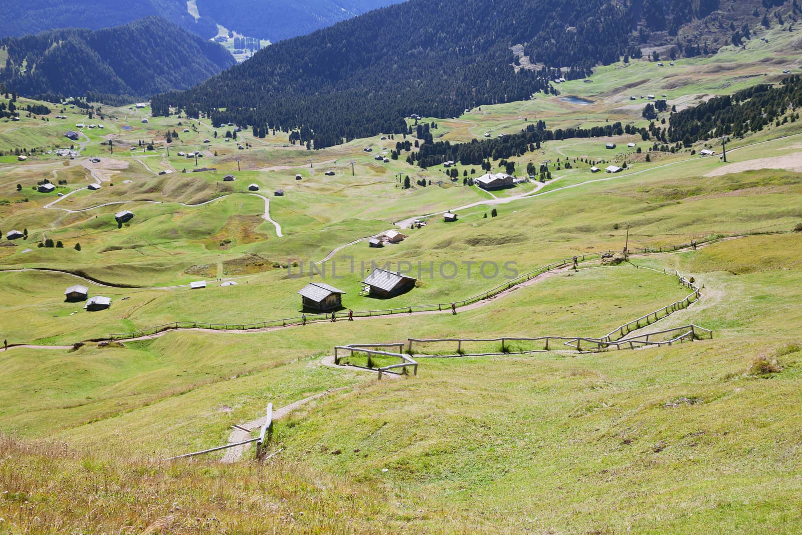 Valley with houses in Dolomite Alps, view from a mountain