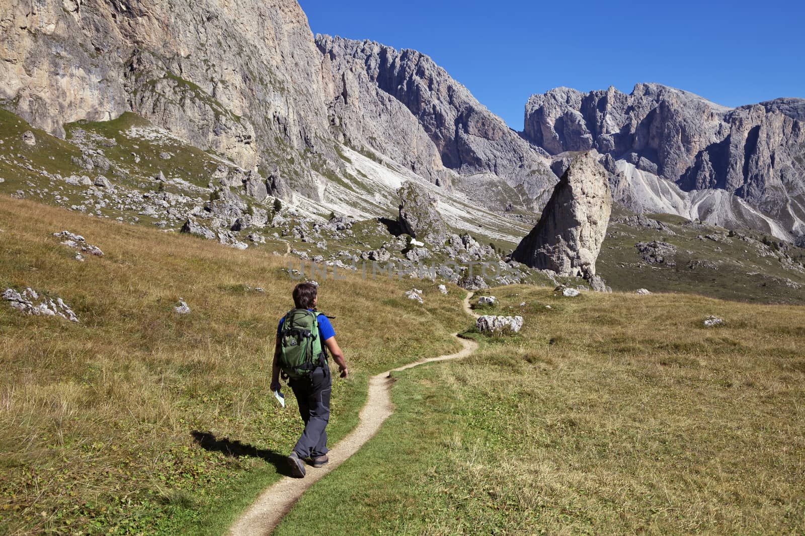 A tourist hiking in Val di Gardena in the Dolomite Alps