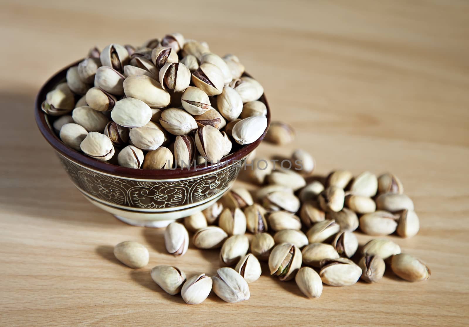 Bowl of pistachio nuts on a table