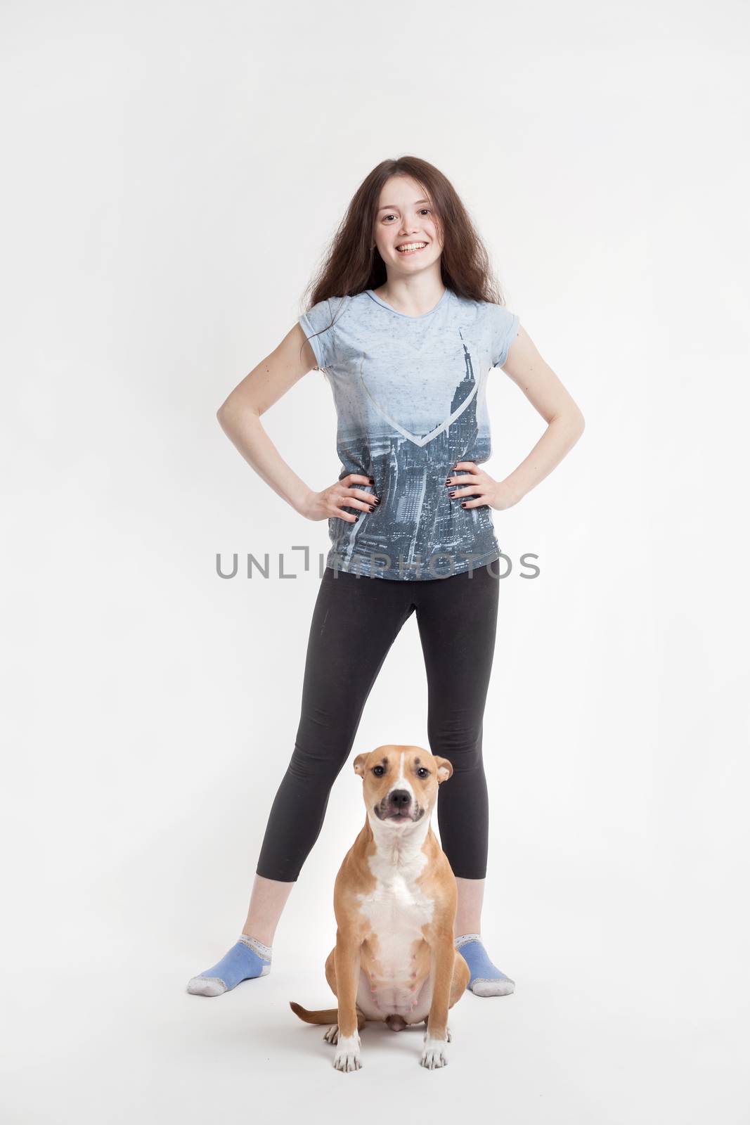 the young beautiful girl and her dog on a white background