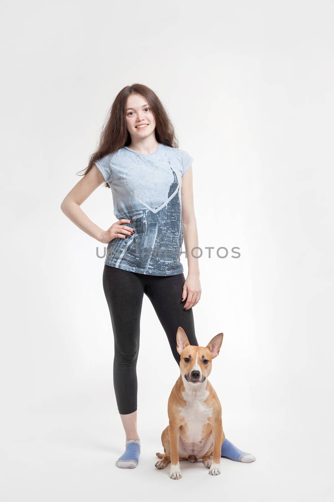 the young beautiful girl and her dog on a white background