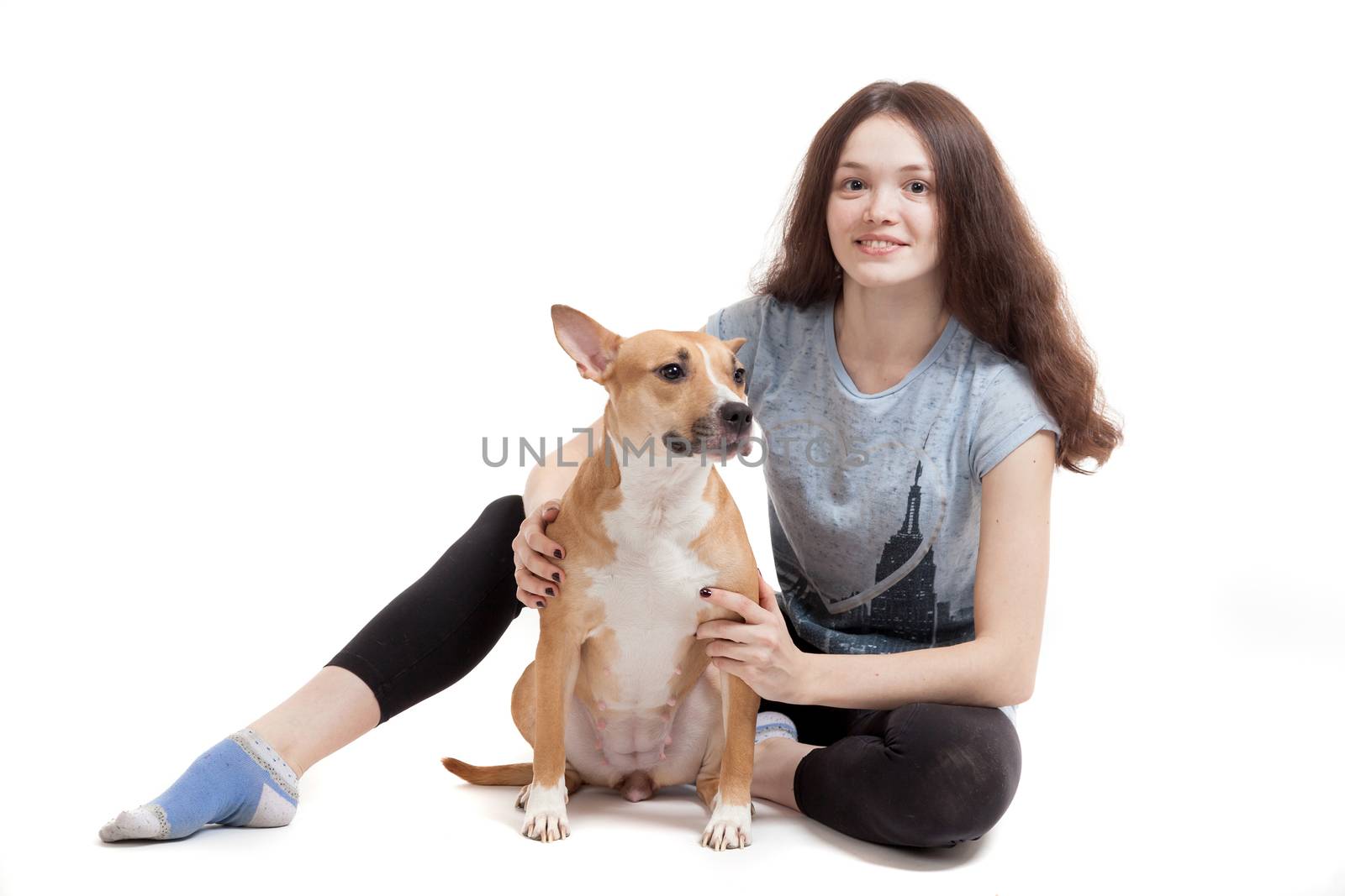 the young beautiful girl embraces a dog