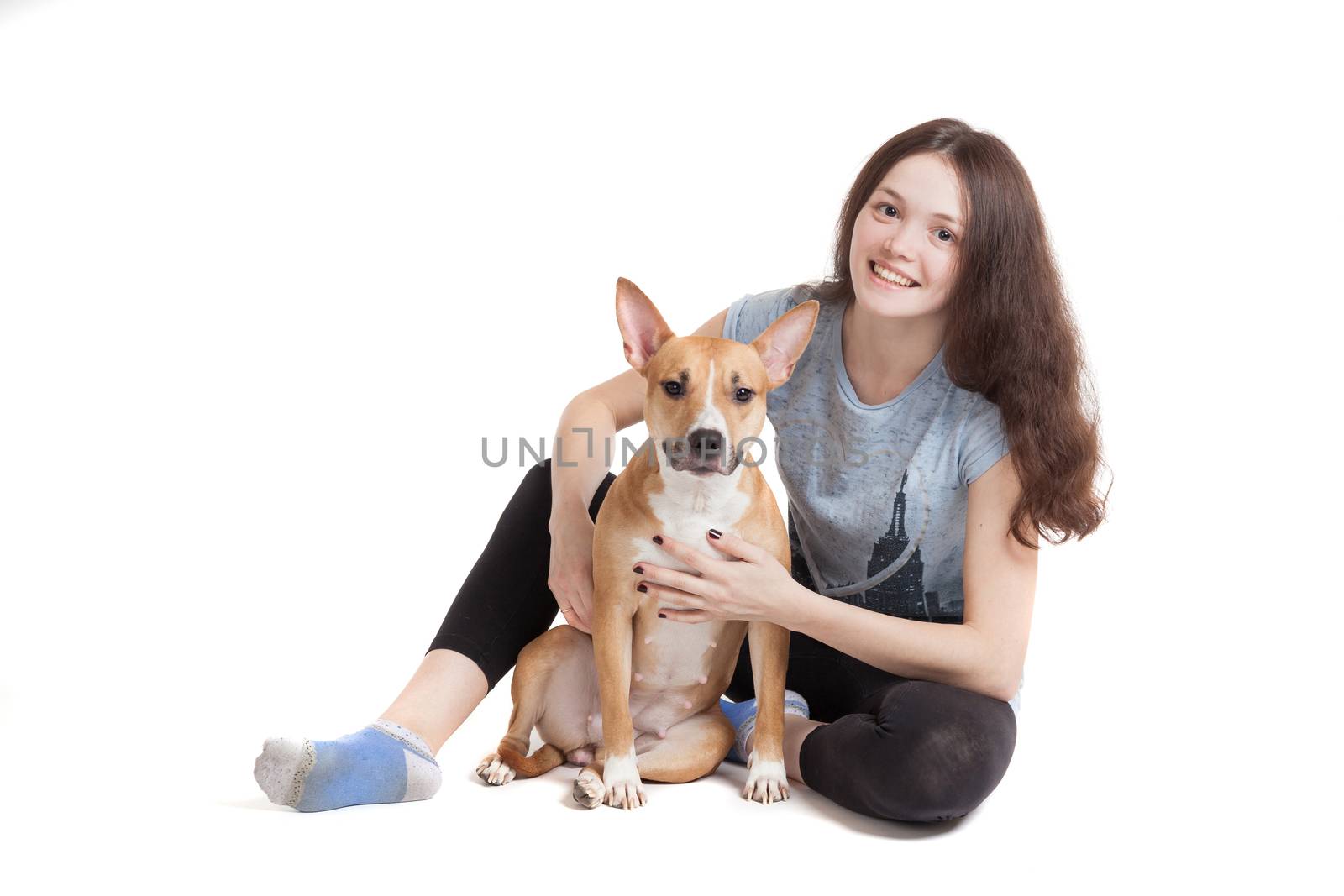 the young beautiful girl embraces a dog