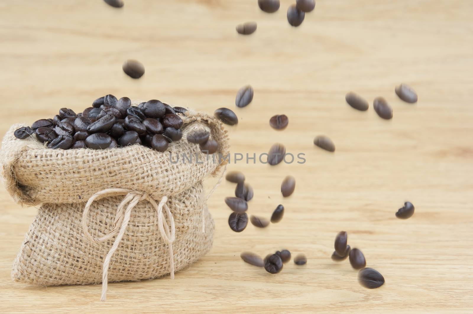 Coffee bean in sack have motion blur of coffee bean by eaglesky