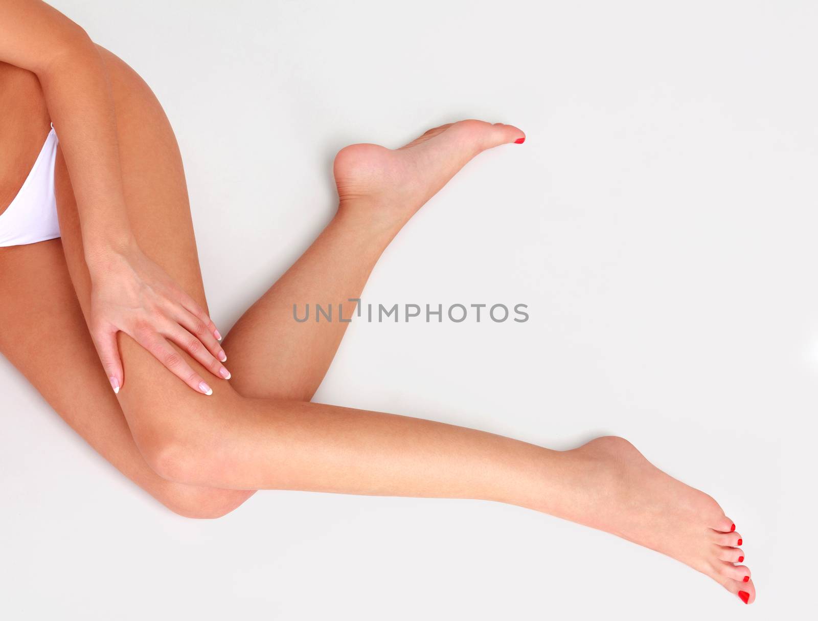 Woman's legs on a light grey floor by Nobilior