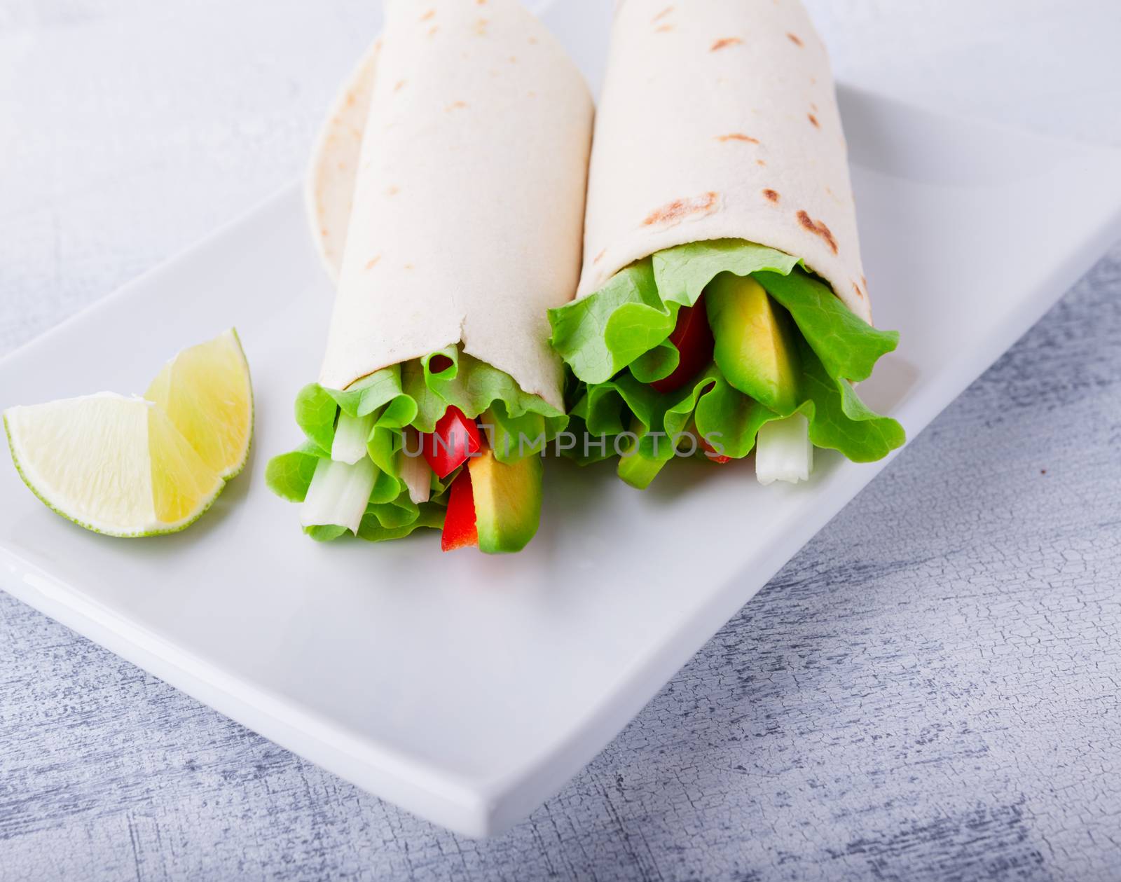 Vegetable wrap sandwiches with greenery and tomatoes