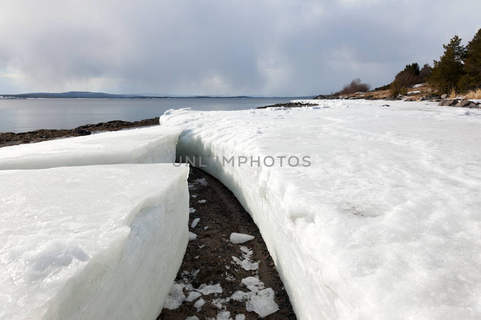 Lumps of ice on the shore of the northern sea by AleksandrN