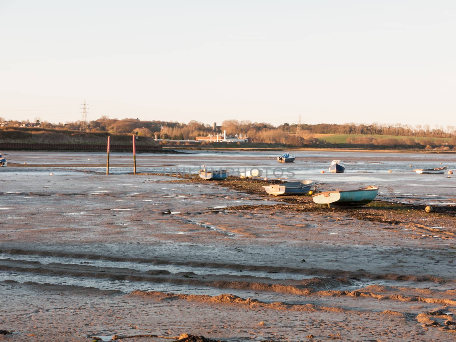 A wonderful shot of the river and its bank with the tide out on a clear day with boats