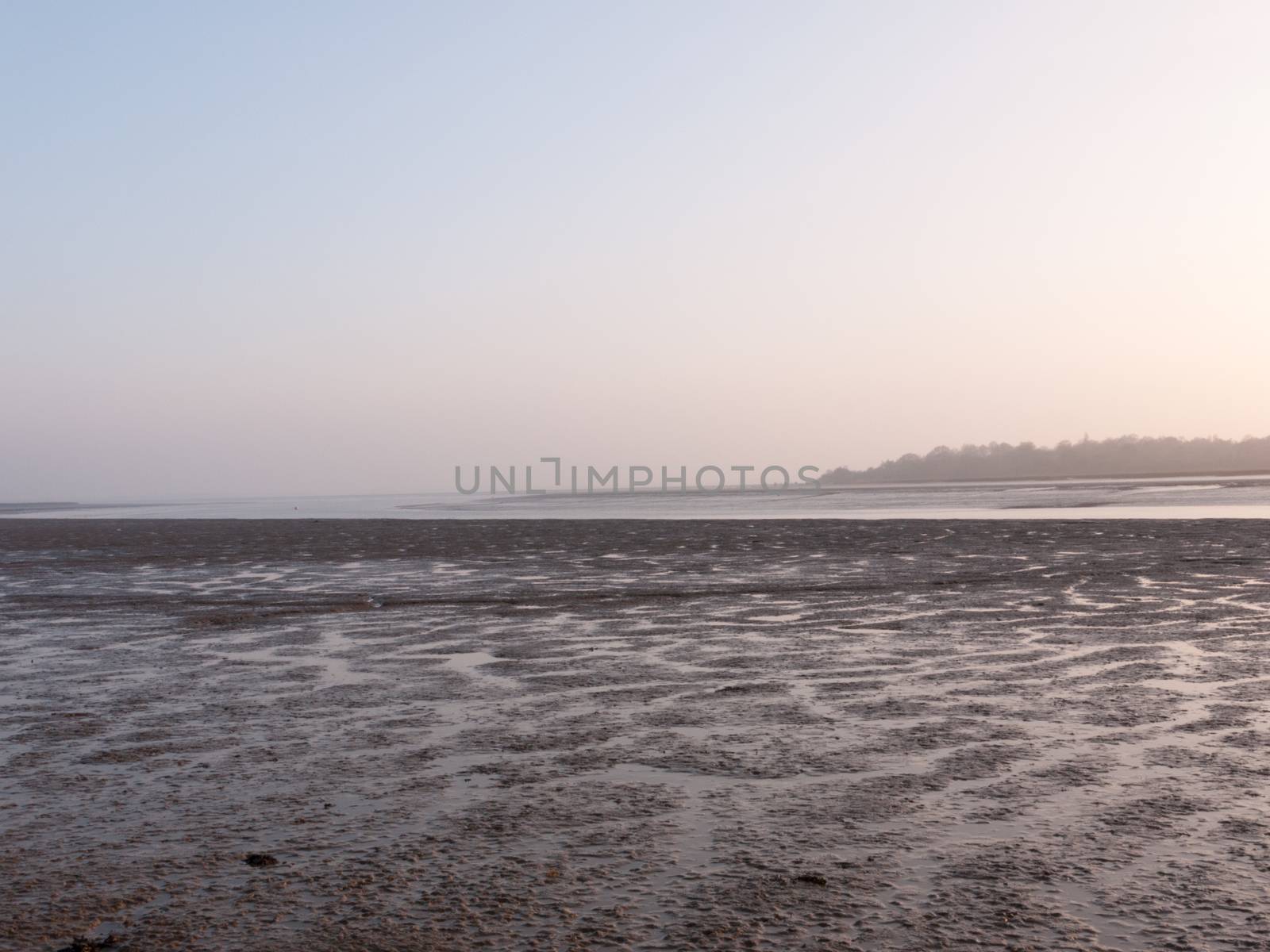 Various shots of the river and the mud, along with many birds, buoys, and other sea structures, as the sun sets