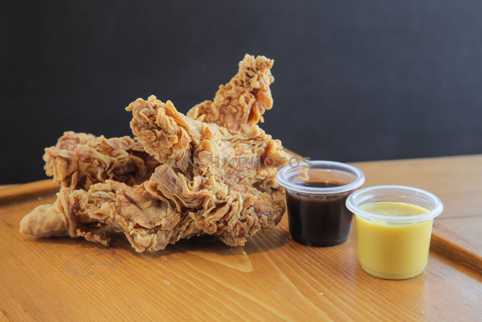 Fried Chicken Strips served with mustard and bbq sauce

