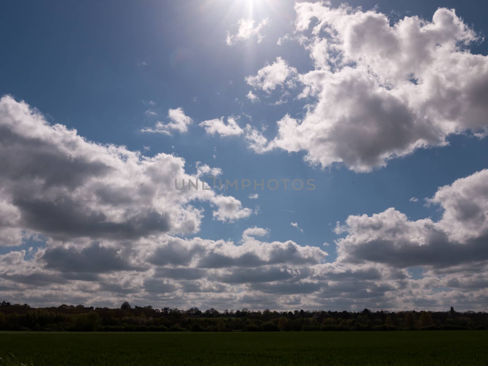 A Lovely Lush Meadow on A Clear Sping Day with Beautiful Clouds and Farm Fields of Plenty of Green Grass and open Space, Freedom and Happiness, and Wellbeing, nobody around, at peace and in heaven