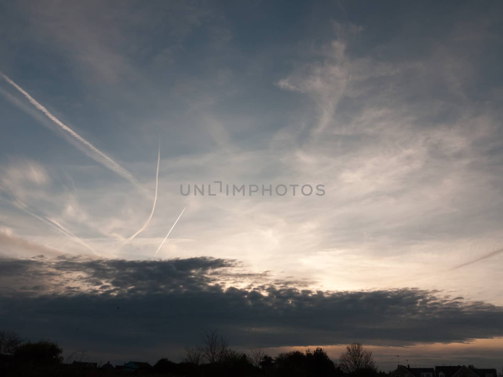 Sunsetting Over a Silhouette of Houses and Trees