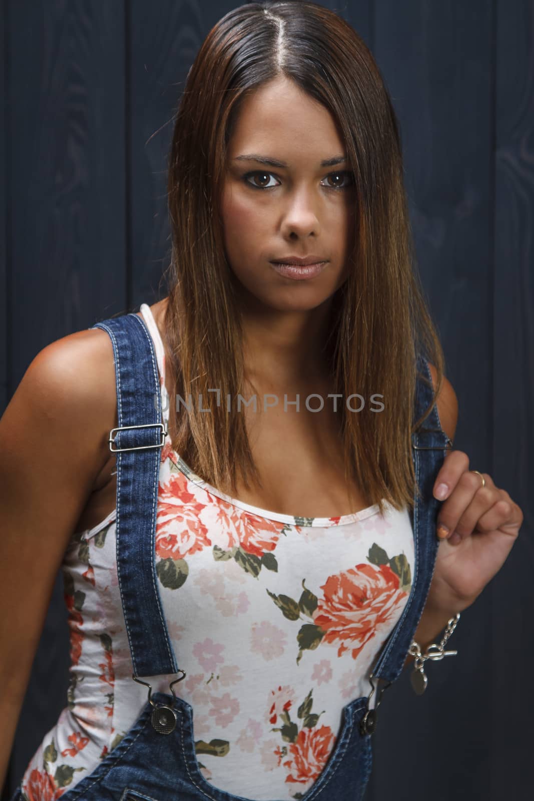 twenty something girl beautiful with floweral pattern tank top and jeans overalls