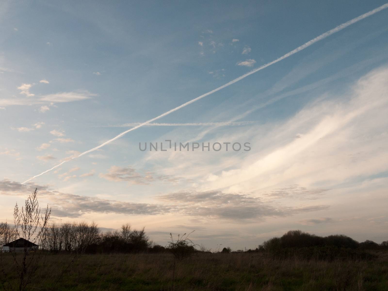 Sunset Silhouette over Fields with Houses in Distance by callumrc