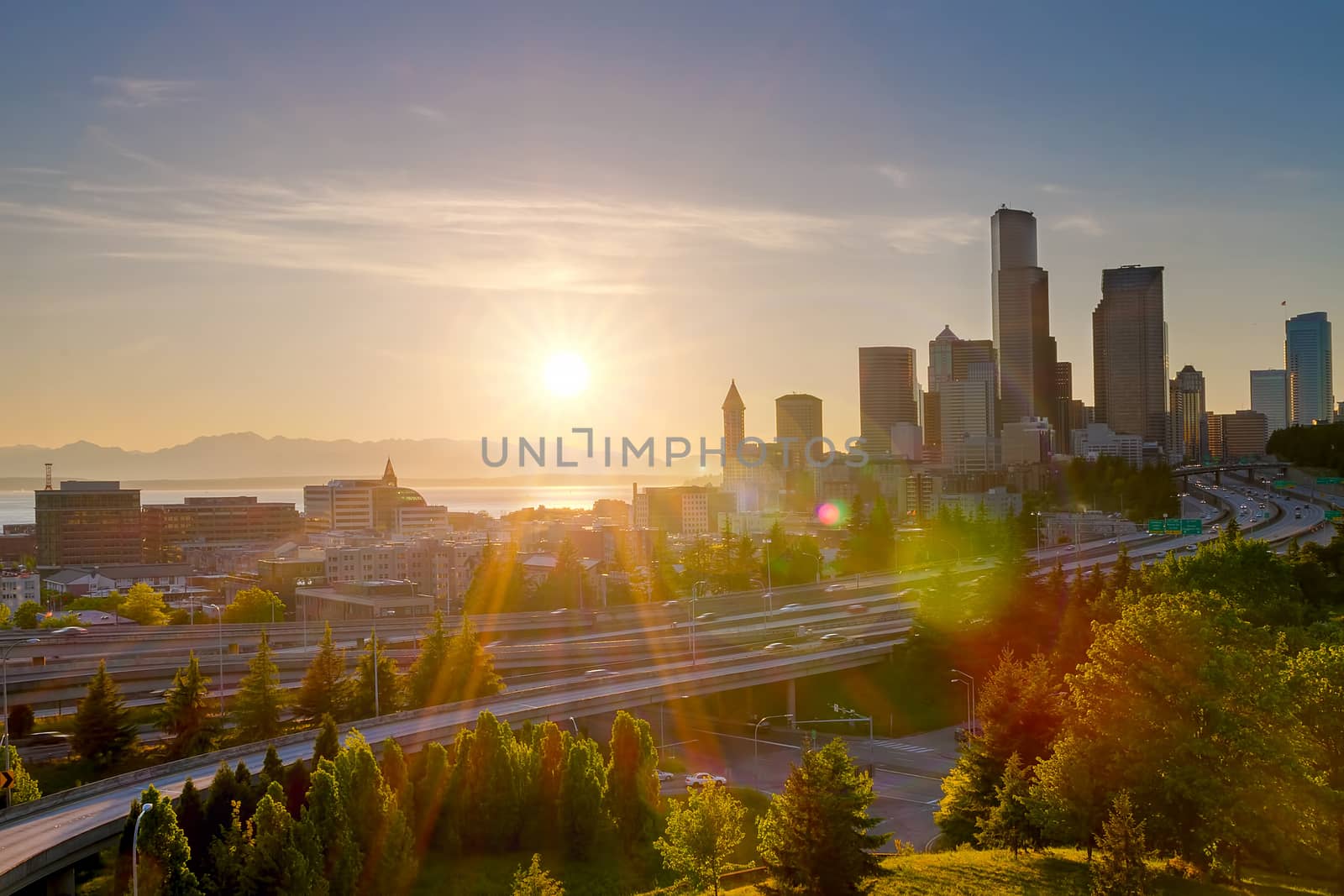 Sunset over Seattle Washington city downtown skyline and freeway on a hazy afternoon
