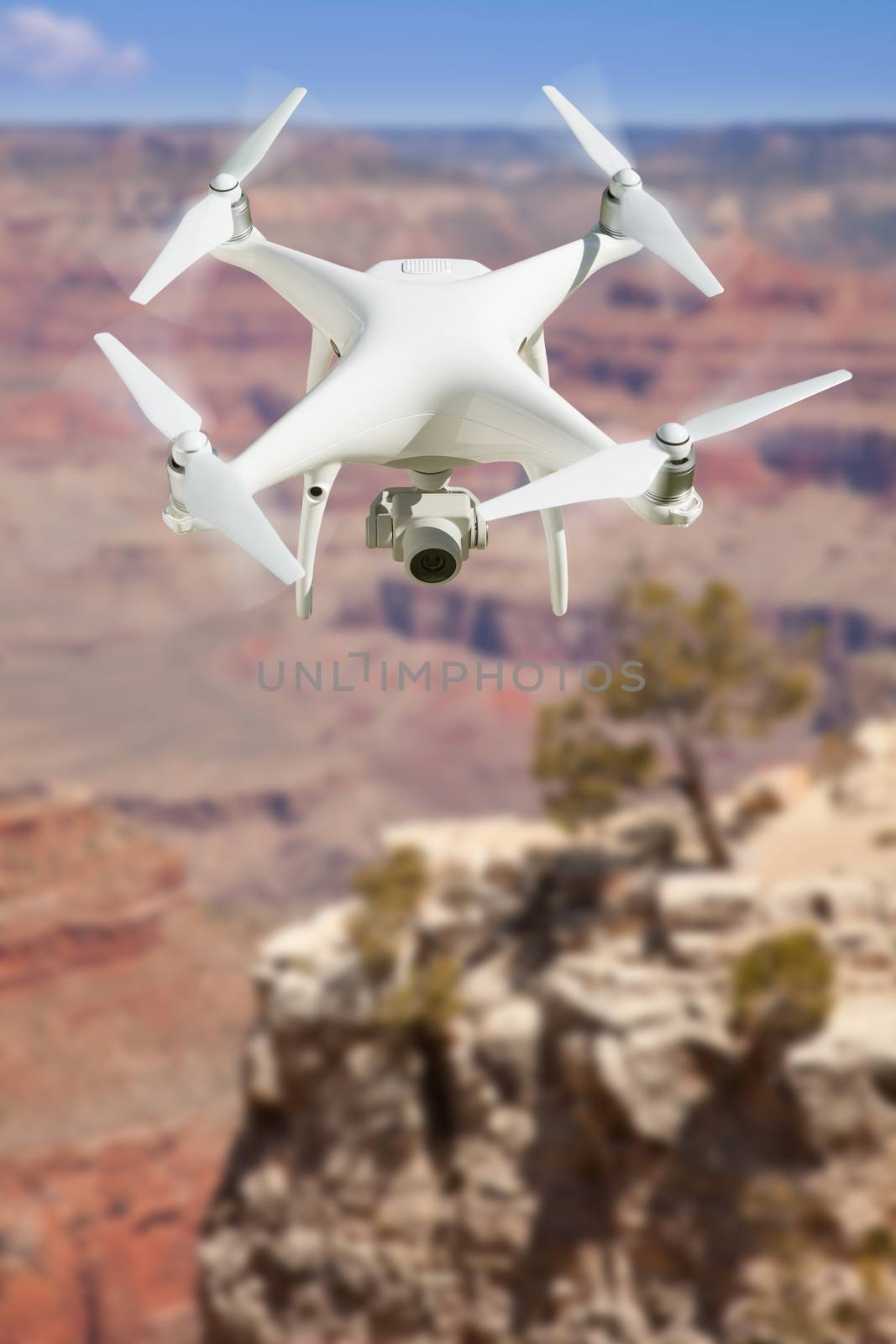 Unmanned Aircraft System (UAV) Quadcopter Drone In The Air Over The Grand Canyon.