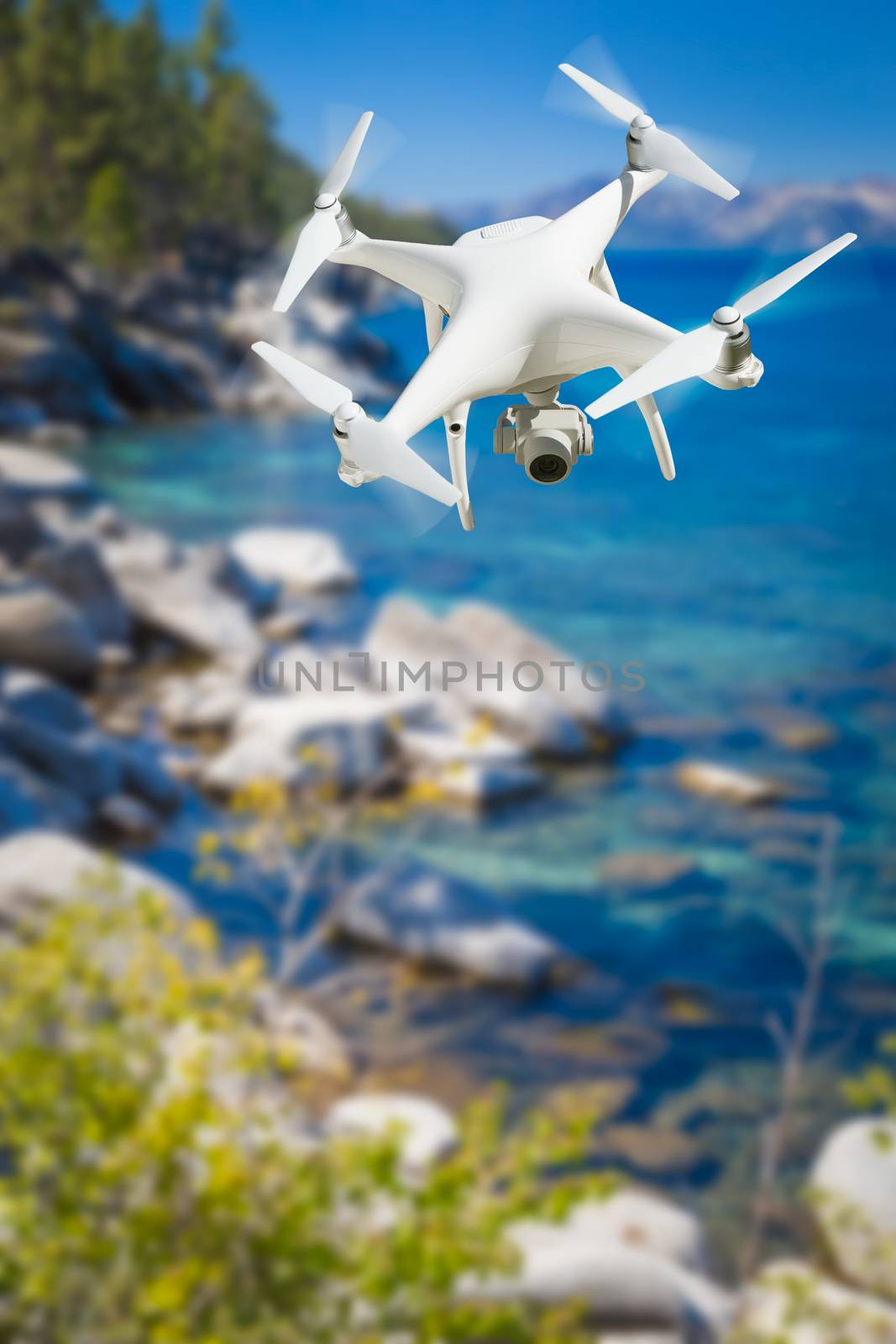 Unmanned Aircraft System (UAV) Quadcopter Drone In The Air Over Lake Tahoe.