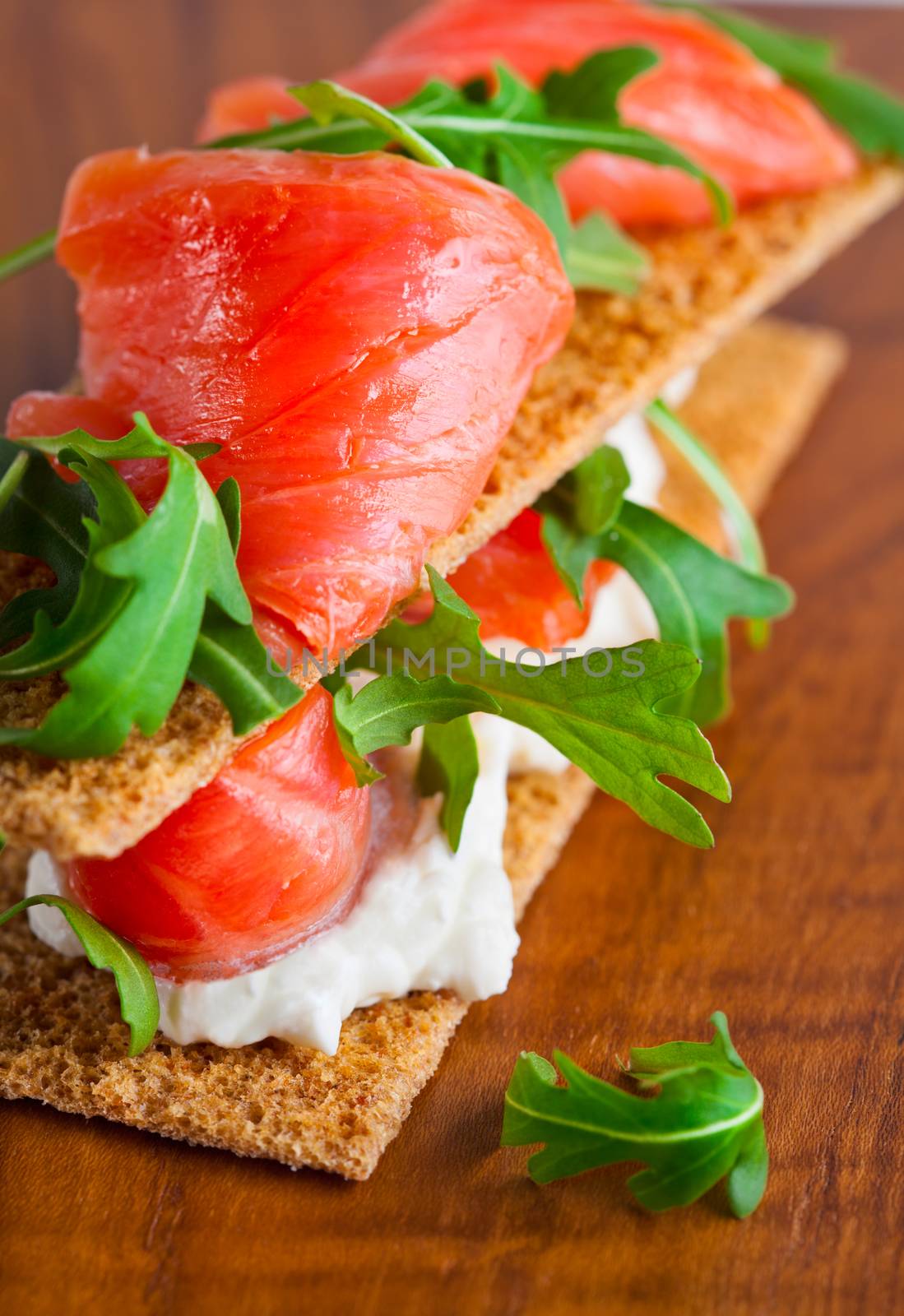 Smoked Salmon on a Healthy Crispbread with Cream Cheese, Fresh Arugula 
