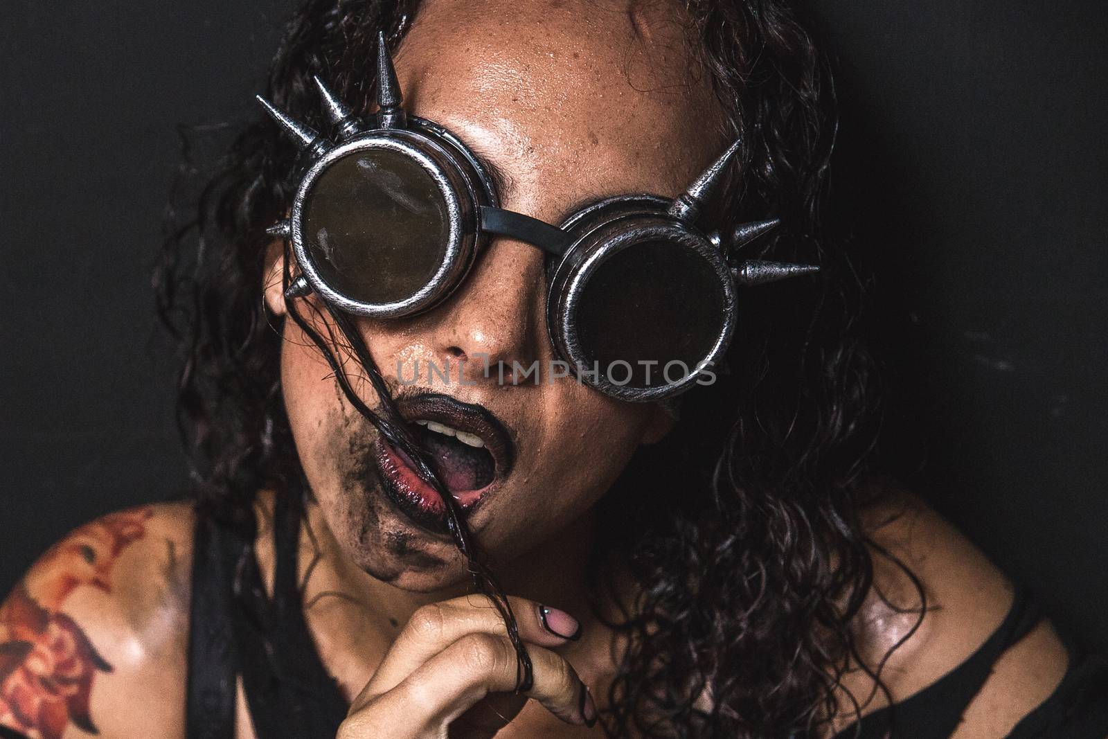 Portrait of Brutal Steampunk Girl over Black Background