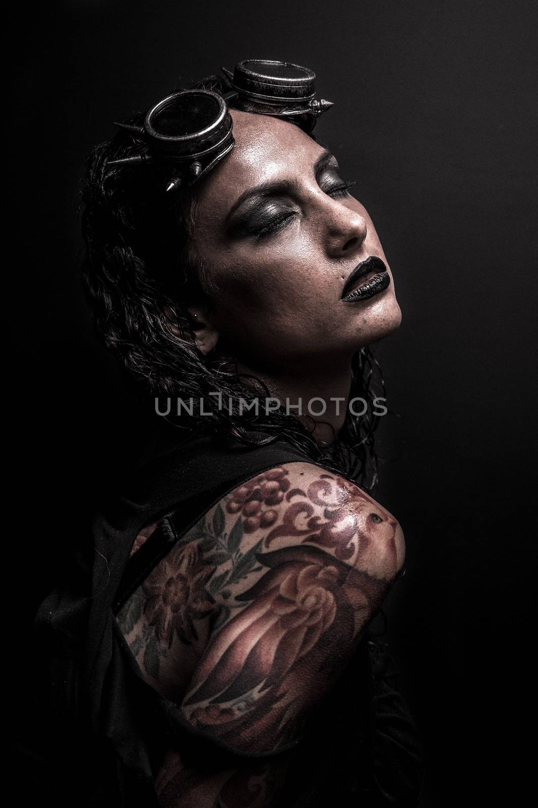 Portrait of Brutal Steampunk Girl over Black Background