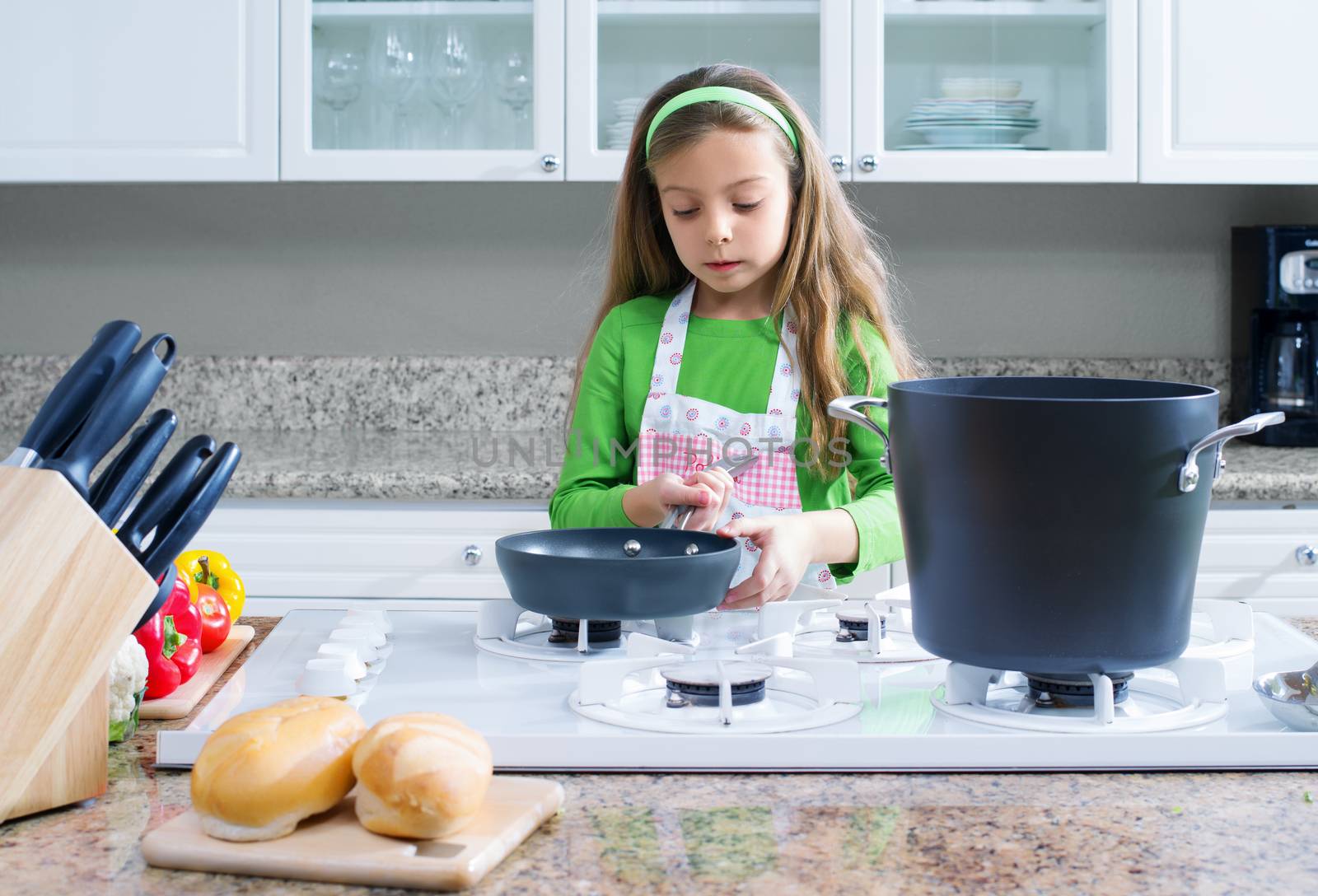 view of young beautiful girl cooking at the kitchen