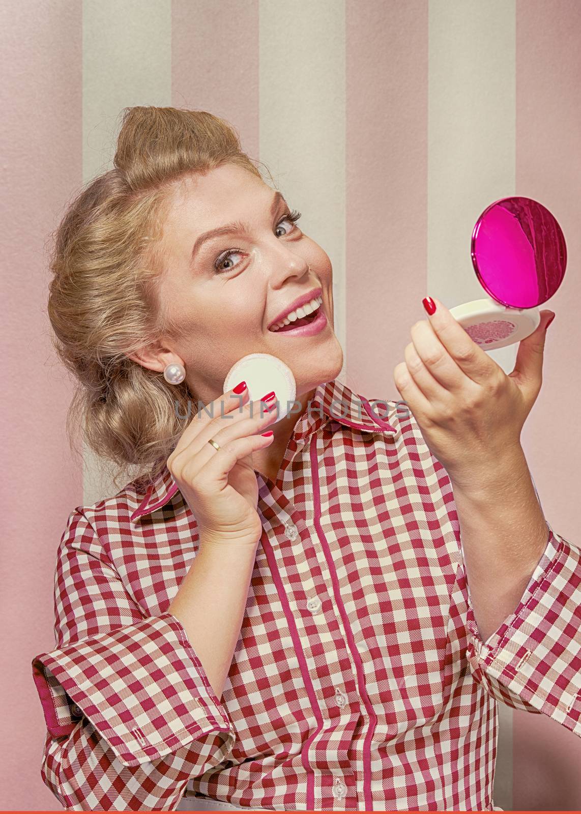 Portrait of nice young  gorgeous woman  doing make up