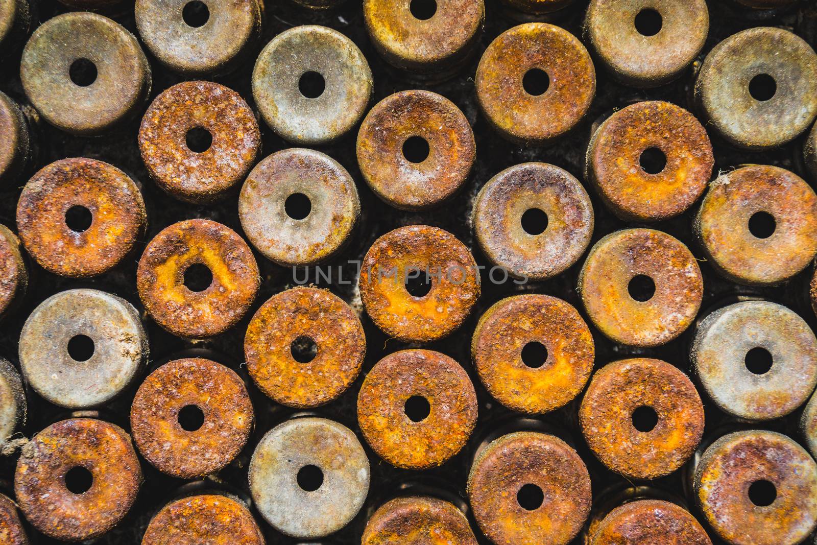 Lot of rust circle aluminum on black background by nopparats