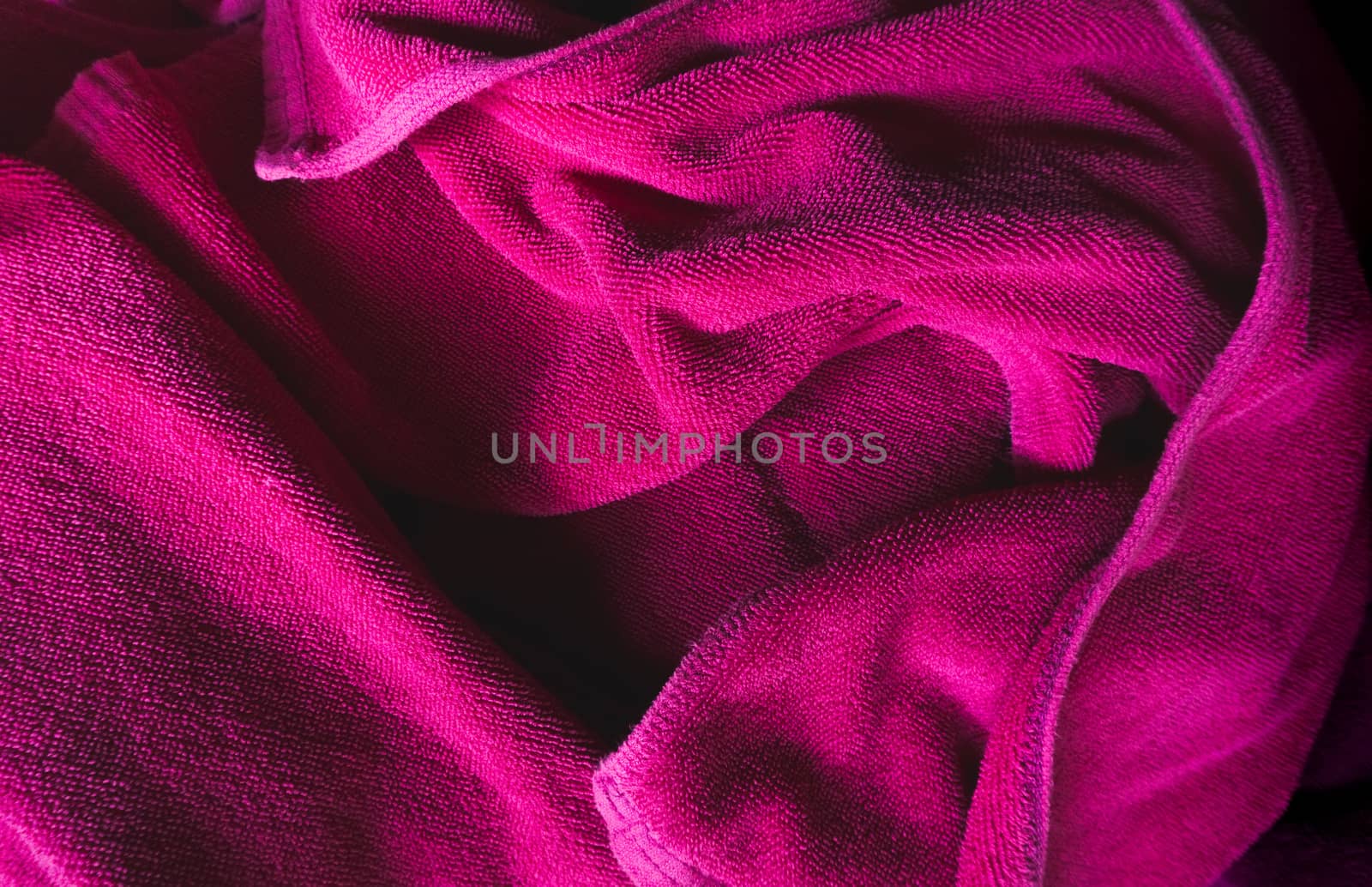 Crumpled purple fabric textile texture background.