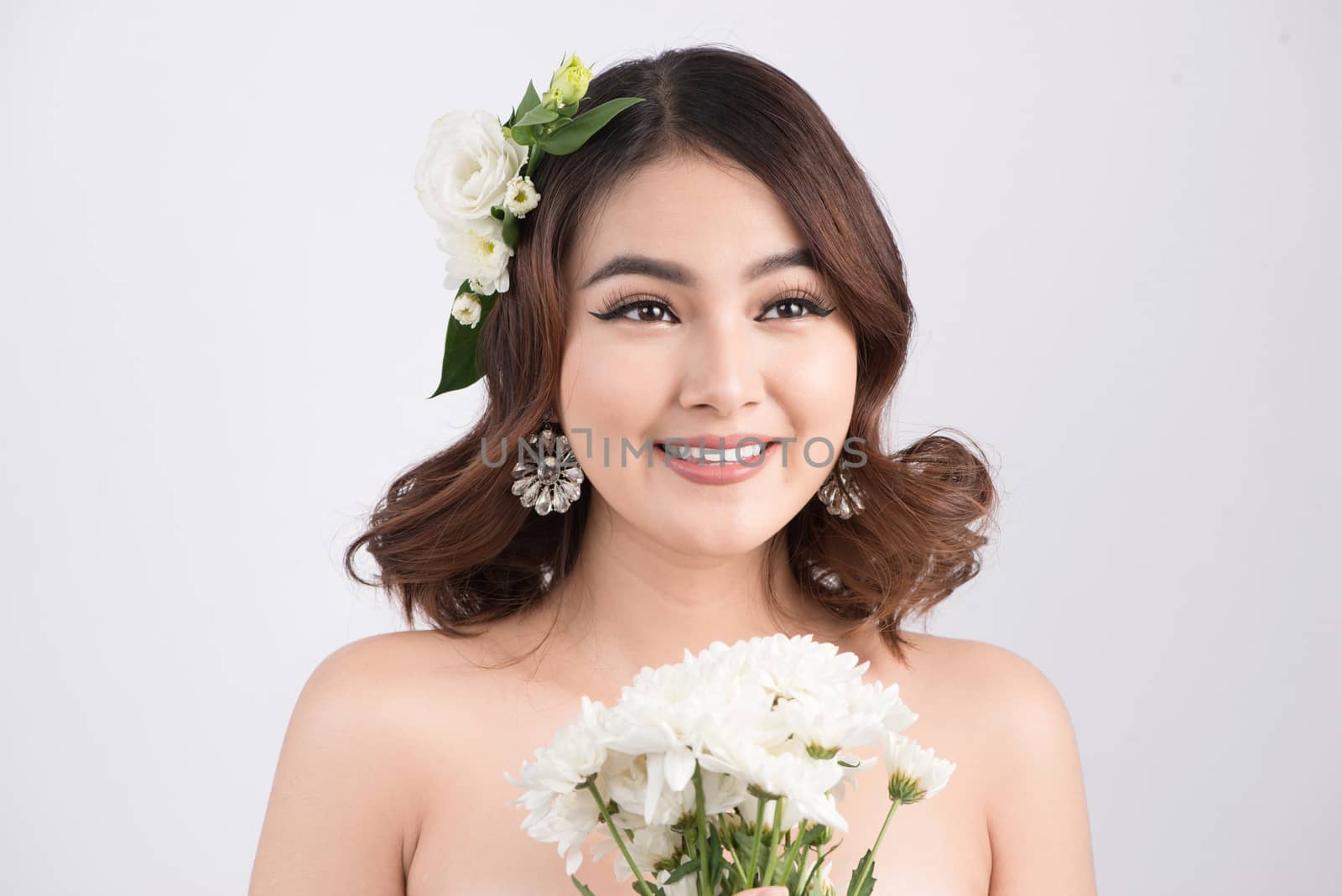 Beautiful asian woman bride on grey background. Closeup portraits with a professional makeup