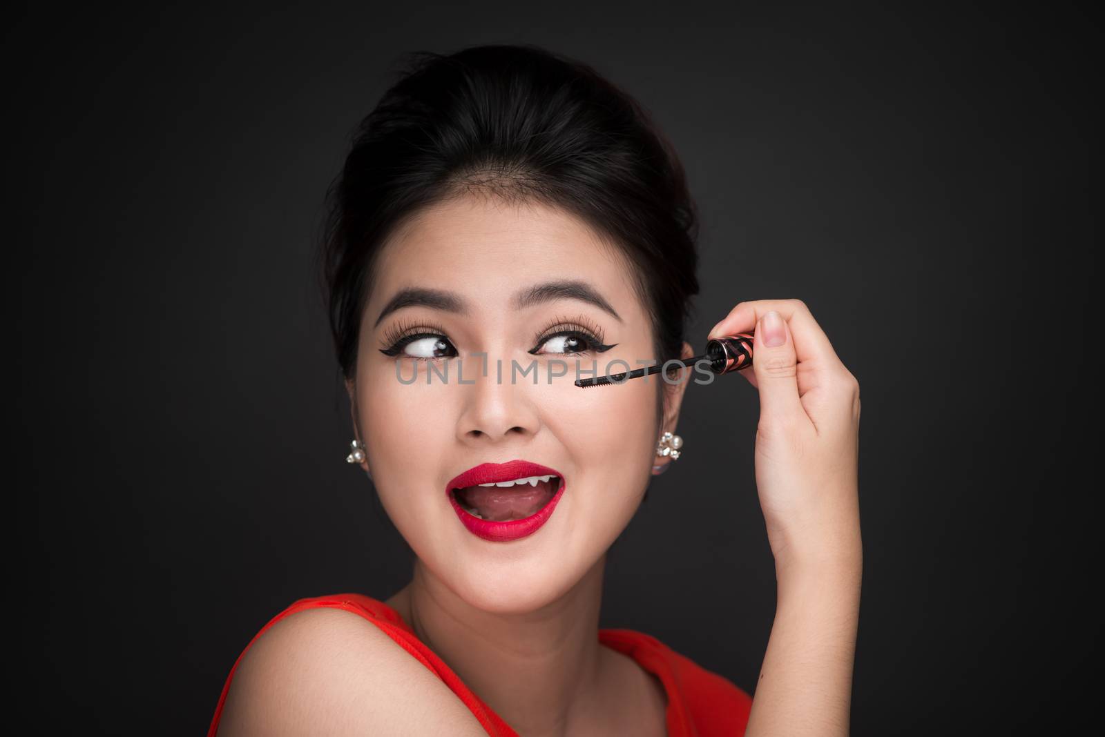 Make-up and cosmetics concept. Asian woman doing her makeup eyel by makidotvn