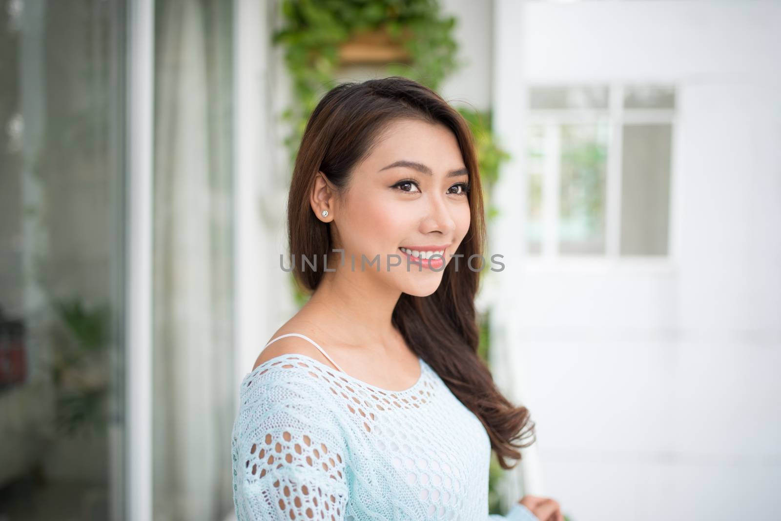 Asian woman enjoying fresh air at home by makidotvn
