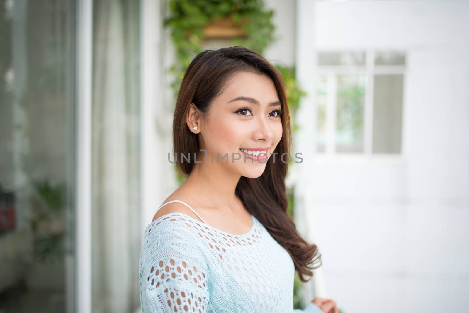 Asian woman enjoying fresh air at home