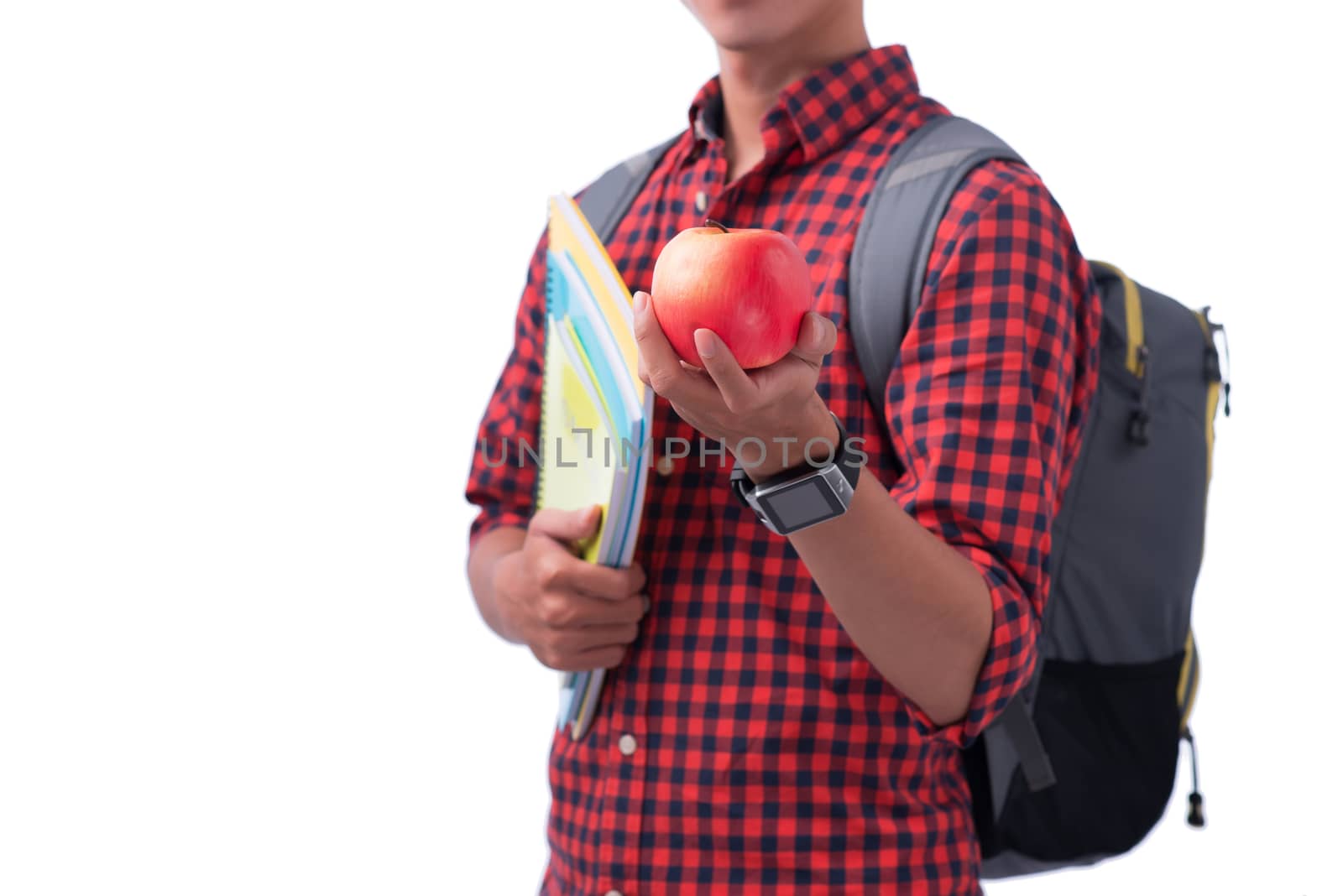 Hands holding red apple with book, isolated on white.