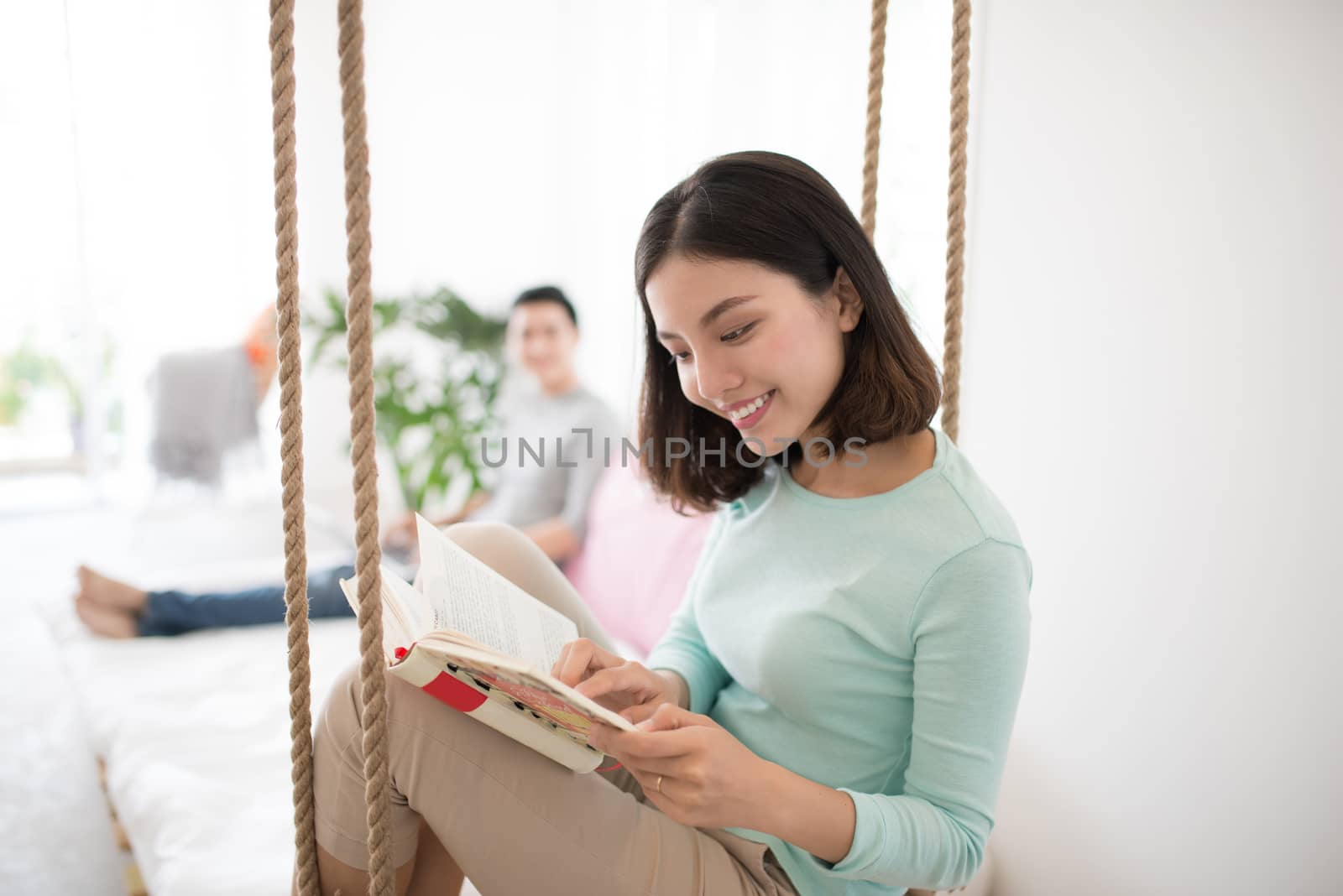 Young pretty asian woman at home relaxing