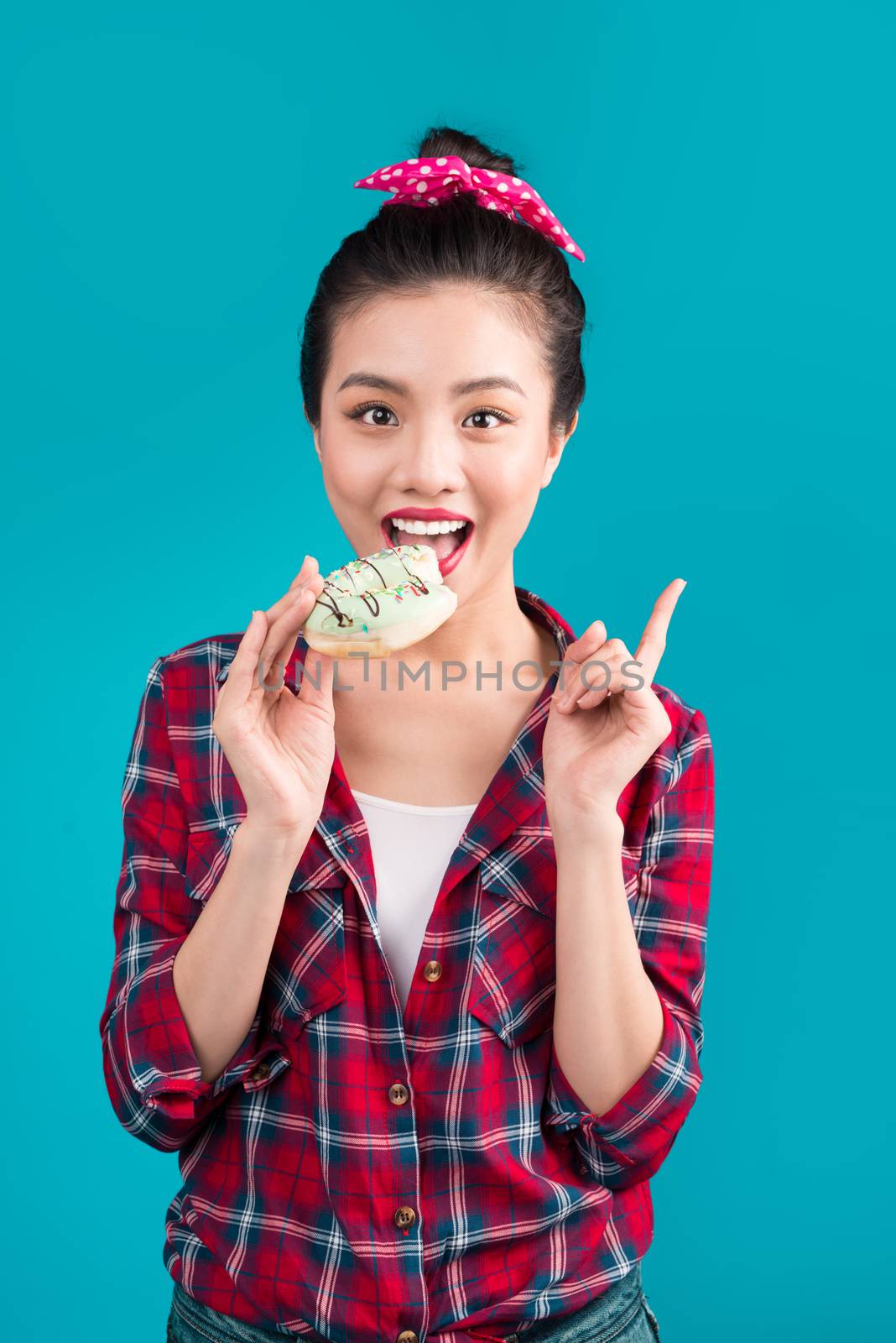 Retro joyful woman enjoy sweets, dessert standing over blue background.