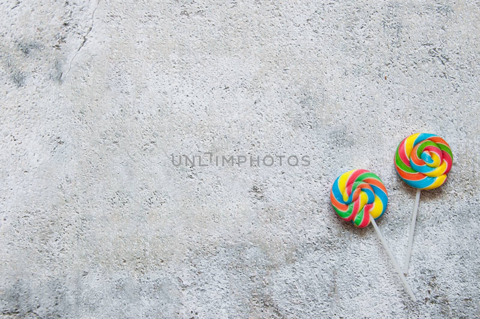 Two lollipops over a shabby chique background