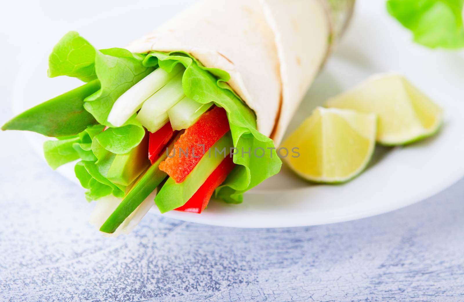 Vegetable wrap sandwiches with greenery and tomatoes