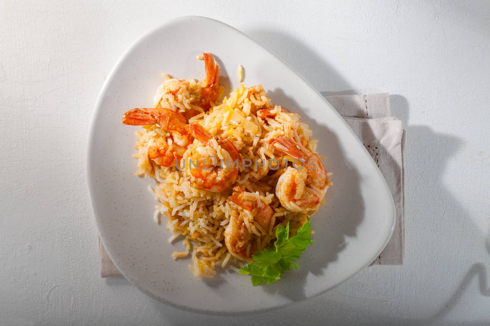 Bowl of fried rice with shrimps and greenery
