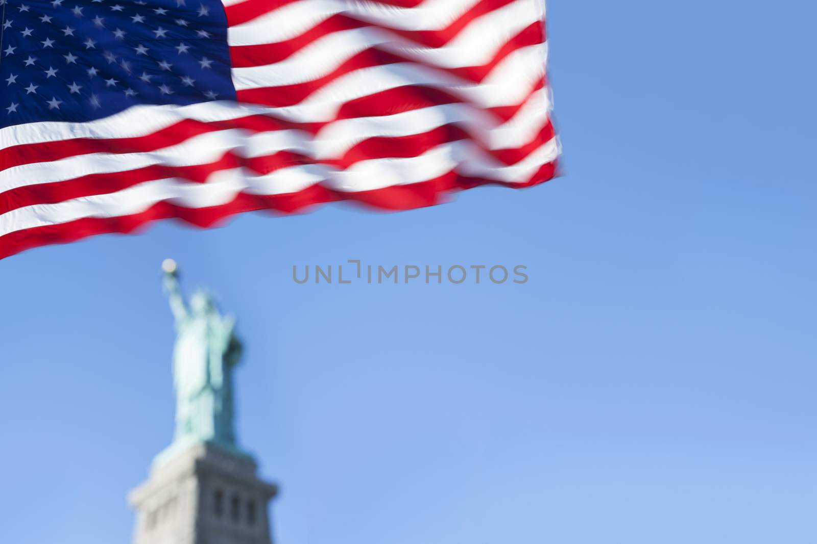 Statue of Liberty and the US Flag, New York City. New York. USA