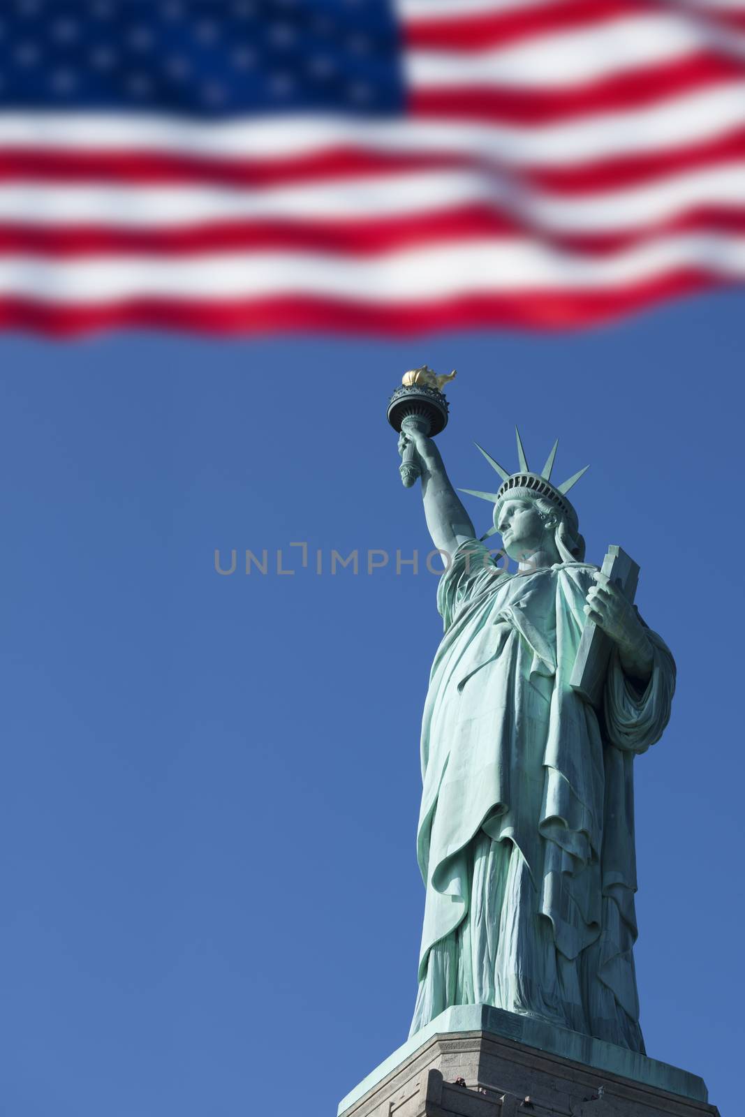 Statue of Liberty and the US Flag, New York City. New York. USA