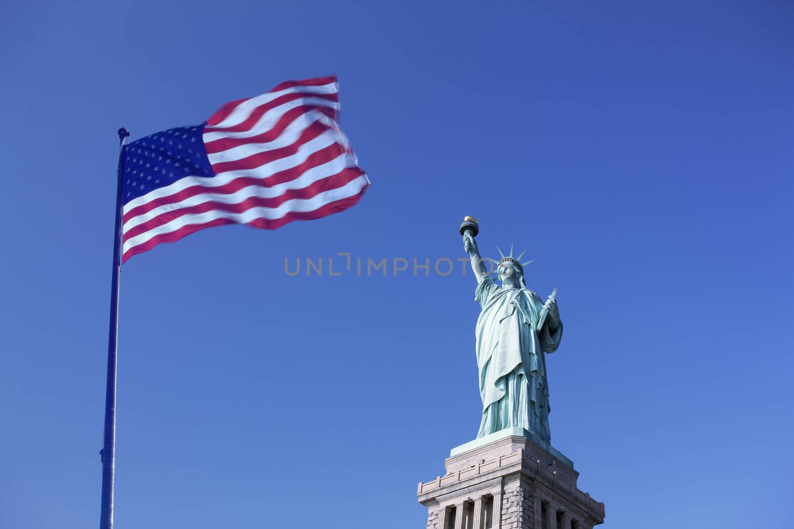 Statue of Liberty and the US Flag, New York City. New York. USA