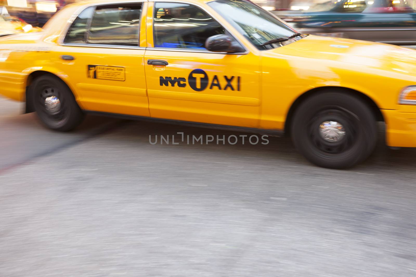 Yellow Taxi Cabin in motion, in Times Square, New York City, New York, USA.