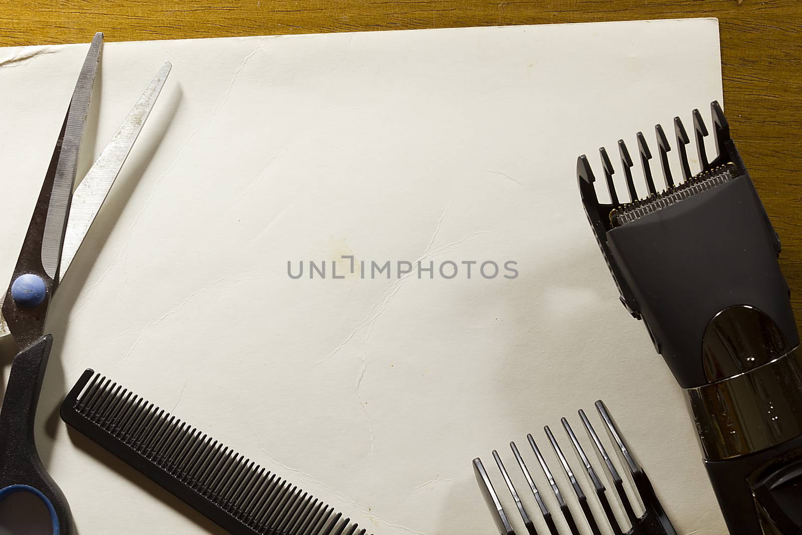 Tools for cutting hair on a white sheet of paper