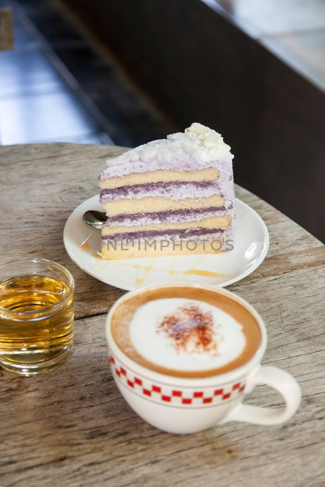 Coffee Break taro cake and Cappuccino coffee on wood table