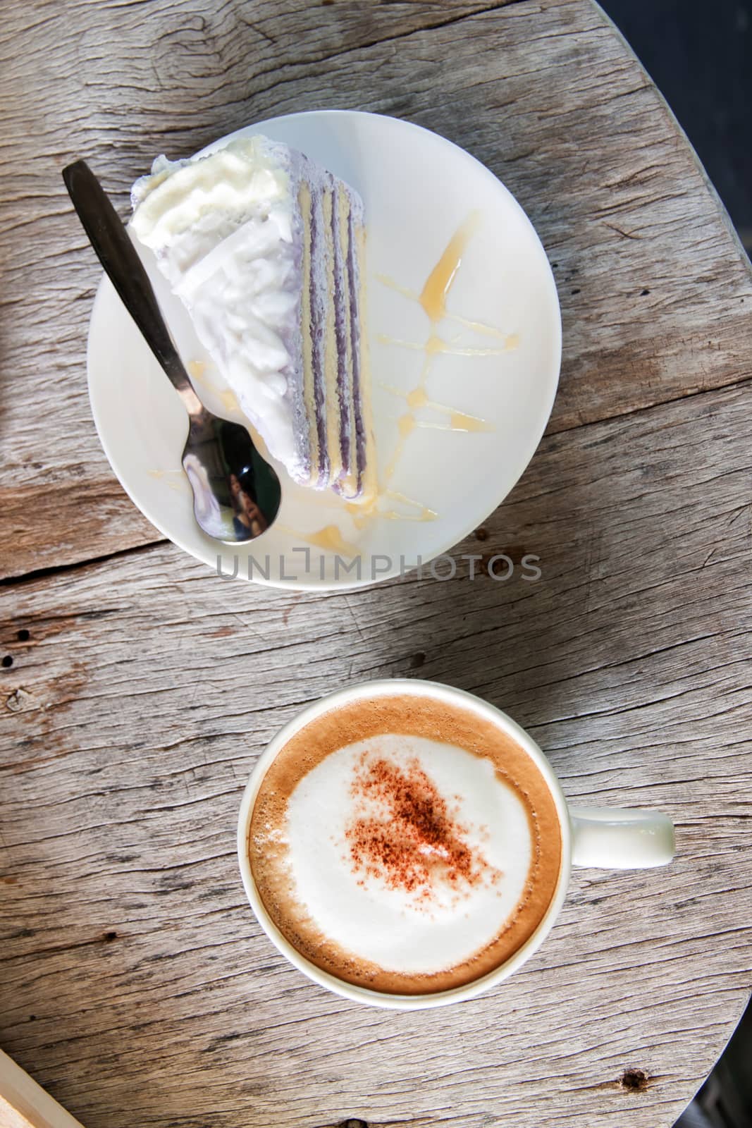 Coffee Break taro cake and Cappuccino coffee on wood table